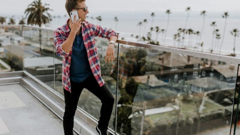 unknown person in red plaid shirt talking on phone at terrace
